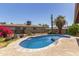 A beautiful, kidney-shaped, blue pool with surrounding concrete at 1715 S Cholla St, Mesa, AZ 85202