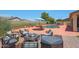 Inviting backyard patio with outdoor seating, a fire pit, and a refreshing pool, ideal for entertaining guests at 18550 W Mcneil St, Goodyear, AZ 85338