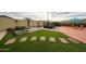 Picturesque backyard featuring artificial grass, stepping stones, and a comfortable seating area, perfect for relaxation at 18550 W Mcneil St, Goodyear, AZ 85338