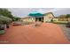 The outdoor space has a refreshing pool, seating, and lush greenery perfect for relaxation at 18550 W Mcneil St, Goodyear, AZ 85338