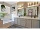 Bright bathroom featuring double sinks, a tub, and modern fixtures near a window at 18550 W Mcneil St, Goodyear, AZ 85338