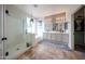 Bright bathroom with double vanity, walk-in shower, and modern lighting fixtures at 18550 W Mcneil St, Goodyear, AZ 85338