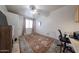 Cozy bedroom with ceiling fan, large area rug and neutral walls creating a peaceful atmosphere at 18550 W Mcneil St, Goodyear, AZ 85338