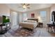 Spacious bedroom featuring a ceiling fan, comfortable bed and modern decor at 18550 W Mcneil St, Goodyear, AZ 85338