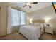 Cozy bedroom with a comfortable bed, neutral décor, and ample natural light at 18550 W Mcneil St, Goodyear, AZ 85338