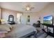 Comfortable bedroom featuring a ceiling fan, TV, and soft, inviting colors at 18550 W Mcneil St, Goodyear, AZ 85338