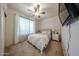 Inviting bedroom with neutral decor, ceiling fan, and soft lighting, creating a serene retreat at 18550 W Mcneil St, Goodyear, AZ 85338