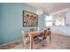 Charming dining room with a wooden table, stylish chairs, and unique artwork at 18550 W Mcneil St, Goodyear, AZ 85338