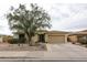 Inviting single-story home featuring a low-maintenance desert landscape and a two-car garage at 18550 W Mcneil St, Goodyear, AZ 85338