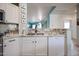 Modern kitchen featuring white cabinetry, stainless steel appliances, and sleek countertops at 18550 W Mcneil St, Goodyear, AZ 85338