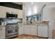 Bright kitchen with stainless appliances, granite counters, and convenient access to the adjacent dining area at 18550 W Mcneil St, Goodyear, AZ 85338