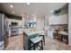 Open-concept kitchen featuring stainless steel appliances, a spacious island, and stylish countertops at 18550 W Mcneil St, Goodyear, AZ 85338