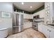 Bright kitchen featuring stainless steel appliances, white cabinetry, and stylish granite countertops at 18550 W Mcneil St, Goodyear, AZ 85338