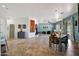 Open-concept living and dining area with tile floors and a fireplace, perfect for entertaining at 18550 W Mcneil St, Goodyear, AZ 85338