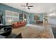 Bright living room with tile floors, comfortable seating, and sliding door access to the outdoors at 18550 W Mcneil St, Goodyear, AZ 85338