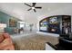 Open-concept living room with a dining area and a view to the modern fireplace at 18550 W Mcneil St, Goodyear, AZ 85338