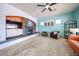 Open-concept living area featuring a stone fireplace and a built-in media center at 18550 W Mcneil St, Goodyear, AZ 85338