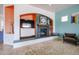 Stylish living room with modern built-ins, a cozy fireplace, and a minimalist design at 18550 W Mcneil St, Goodyear, AZ 85338