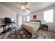 Spacious main bedroom with ceiling fan, neutral carpet, and ensuite bathroom at 18550 W Mcneil St, Goodyear, AZ 85338