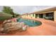 Enjoy the backyard's kidney-shaped pool with rock accents, and a cool blue hue at 18550 W Mcneil St, Goodyear, AZ 85338