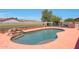 Inviting pool with a rock waterfall feature and a spacious deck area for lounging at 18550 W Mcneil St, Goodyear, AZ 85338