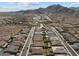 An aerial view of homes in a desert neighborhood near mountains at 21132 W Windsor Ave, Buckeye, AZ 85396