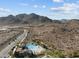 Community pool set against a desert landscape with stunning mountain views, offering a serene residential oasis at 21132 W Windsor Ave, Buckeye, AZ 85396