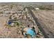 Stunning aerial view of a vibrant community with a sparkling pool and well-maintained amenities at 21132 W Windsor Ave, Buckeye, AZ 85396