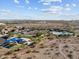 Aerial shot of community pool, ramada, playground, and desert landscape showcasing the available community amenities at 21132 W Windsor Ave, Buckeye, AZ 85396