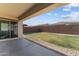 The backyard features a covered patio, rock border, and a lawn for outdoor enjoyment at 21132 W Windsor Ave, Buckeye, AZ 85396