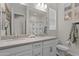 Bathroom with double sinks, white cabinets and gray countertop at 21132 W Windsor Ave, Buckeye, AZ 85396