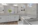 Elegant bathroom featuring double sinks, a soaking tub, and a glass-enclosed shower at 21132 W Windsor Ave, Buckeye, AZ 85396