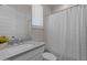 Bathroom with white vanity, gray countertop, and tiled shower with modern fixtures at 21132 W Windsor Ave, Buckeye, AZ 85396