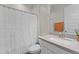 Bathroom with a shower with white shower curtain, white vanity and gray countertop at 21132 W Windsor Ave, Buckeye, AZ 85396