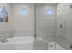 Bathroom featuring a shower, soaking tub, and natural light through the windows at 21132 W Windsor Ave, Buckeye, AZ 85396