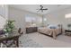 Neutral bedroom featuring a cozy bed, dresser, desk, and fan at 21132 W Windsor Ave, Buckeye, AZ 85396