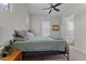 Bedroom with green bedding, carpeted floors, ceiling fan, and window at 21132 W Windsor Ave, Buckeye, AZ 85396