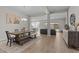Open-concept dining room with a rustic wood table and chairs, seamlessly connected to the living area at 21132 W Windsor Ave, Buckeye, AZ 85396