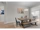 Dining room with a wooden table, bench, and chandelier; seamlessly connects to kitchen and other living areas at 21132 W Windsor Ave, Buckeye, AZ 85396