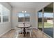 Cozy dining area with a round table next to glass doors and bright windows at 21132 W Windsor Ave, Buckeye, AZ 85396
