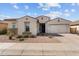 Charming single-story home featuring a well-manicured front yard, paver driveway, and a two-car garage at 21132 W Windsor Ave, Buckeye, AZ 85396