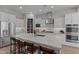 Bright, all-white kitchen with a large island, stainless steel appliances, and a walk-in pantry at 21132 W Windsor Ave, Buckeye, AZ 85396
