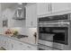 Close-up of modern kitchen features stainless steel appliances and white cabinetry at 21132 W Windsor Ave, Buckeye, AZ 85396