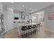 Bright, all-white kitchen featuring a large island with seating, stainless steel appliances, and modern finishes at 21132 W Windsor Ave, Buckeye, AZ 85396