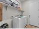 Laundry room featuring new washer and dryer, shelving, and wood-look flooring at 21132 W Windsor Ave, Buckeye, AZ 85396