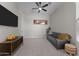 Living Room with neutral walls, carpeted floors, ceiling fan, and TV at 21132 W Windsor Ave, Buckeye, AZ 85396