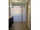 Bright bathroom with a patterned shower curtain, tile floor, and vanity at 21544 W Watkins St, Buckeye, AZ 85326