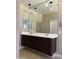 Bathroom vanity with double sinks, framed mirrors, and pendant lighting above at 21544 W Watkins St, Buckeye, AZ 85326