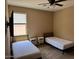 Bedroom featuring two beds, a ceiling fan, and a window providing natural light at 21544 W Watkins St, Buckeye, AZ 85326