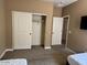 Bedroom showcasing a sliding closet and light-colored walls and carpet at 21544 W Watkins St, Buckeye, AZ 85326